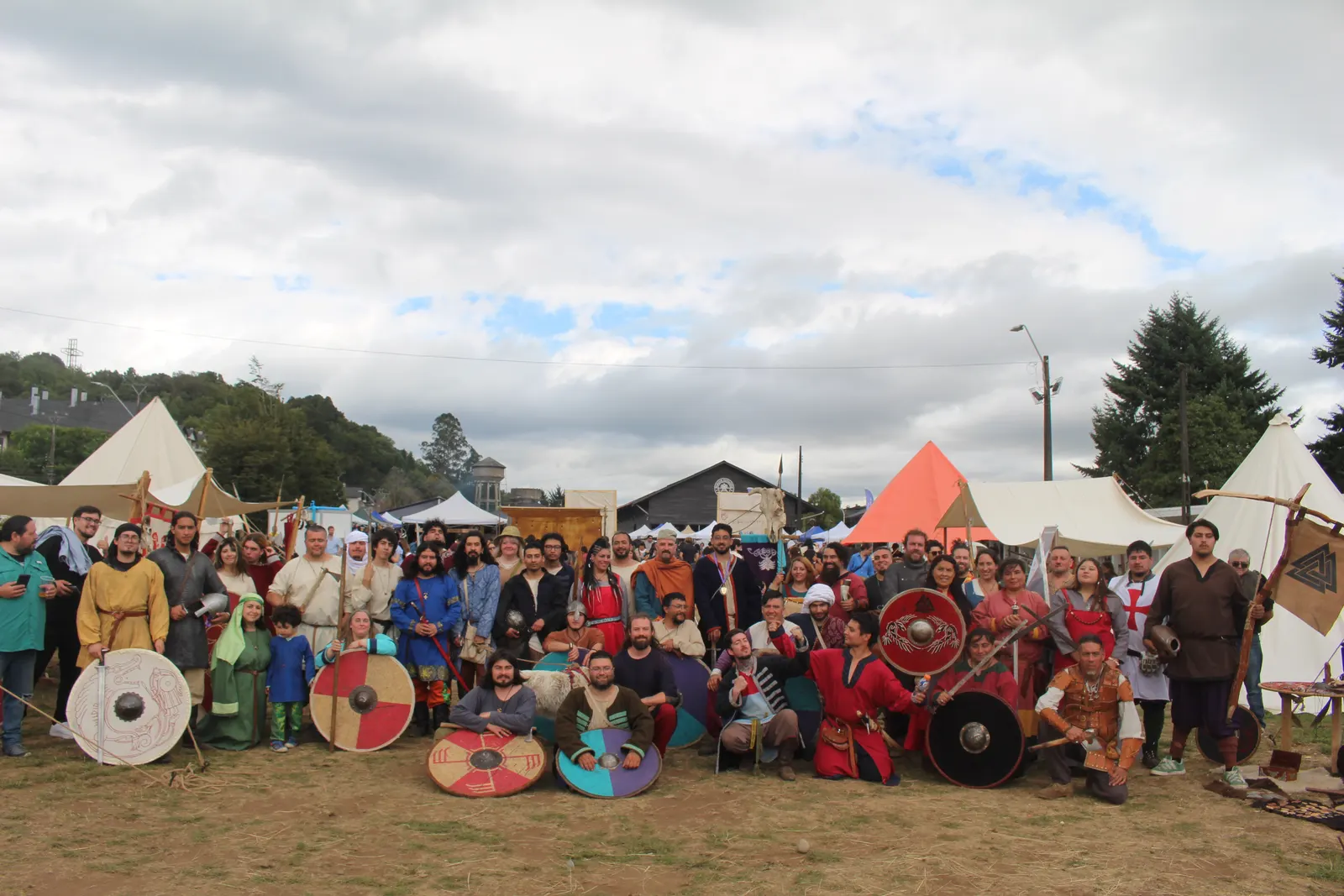 Foto grupal de participantes de Feudo Medieval con trajes y escudos